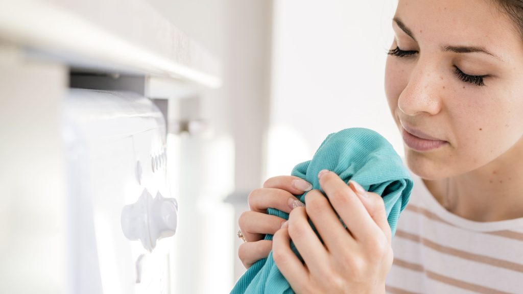 woman blue shirt ironing in home