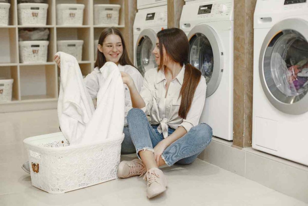 women-using-washing-machine-doing-laundry-young-girls-ready-wash-clothes-interior-washing-process-concept-min-1
