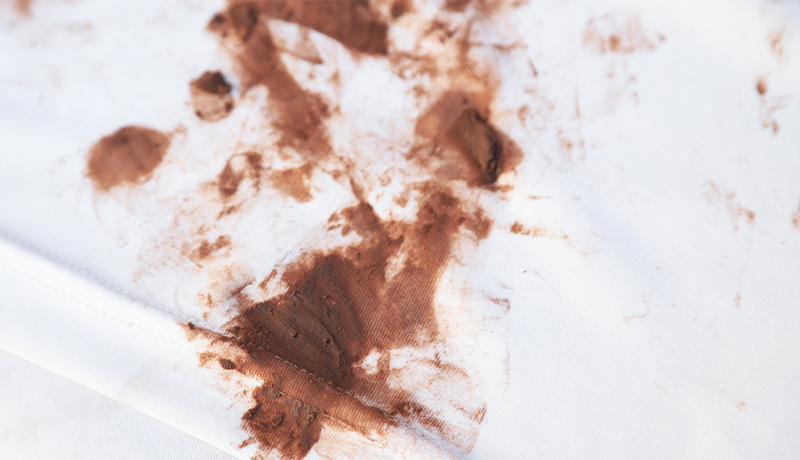 Close-up View of a Difficult Chocolate Stain on White Fabric, Illustrating the Starting Point for Stain Removal